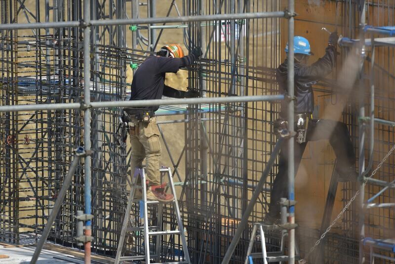 鉄筋のチェックをする職人たち